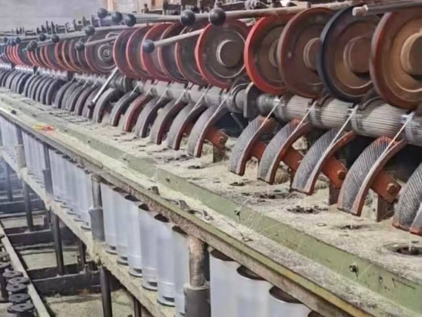 Yarn emerging from spinning equipment